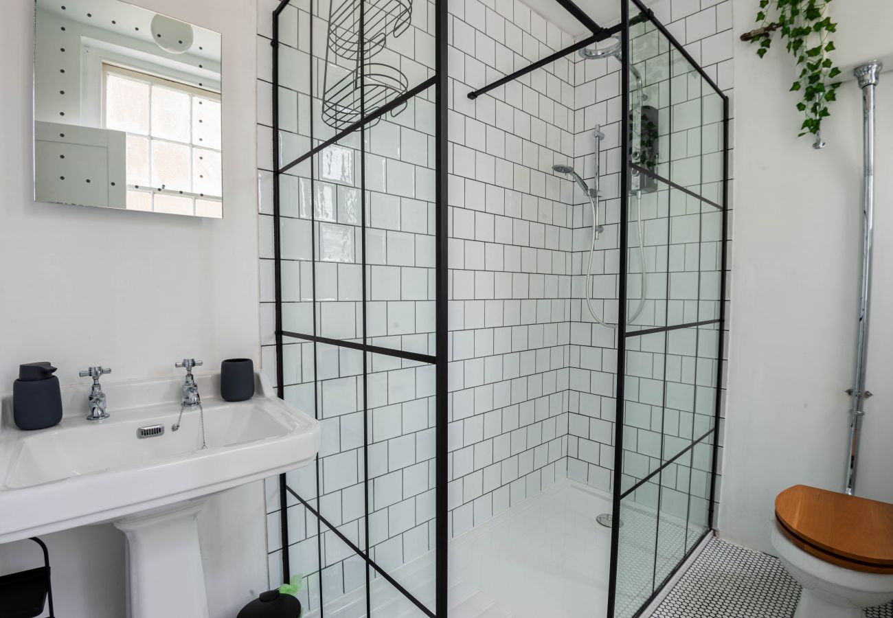 Walk-in shower room with black framed screen